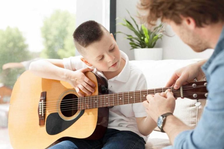 tutor boy playing guitar 768x512